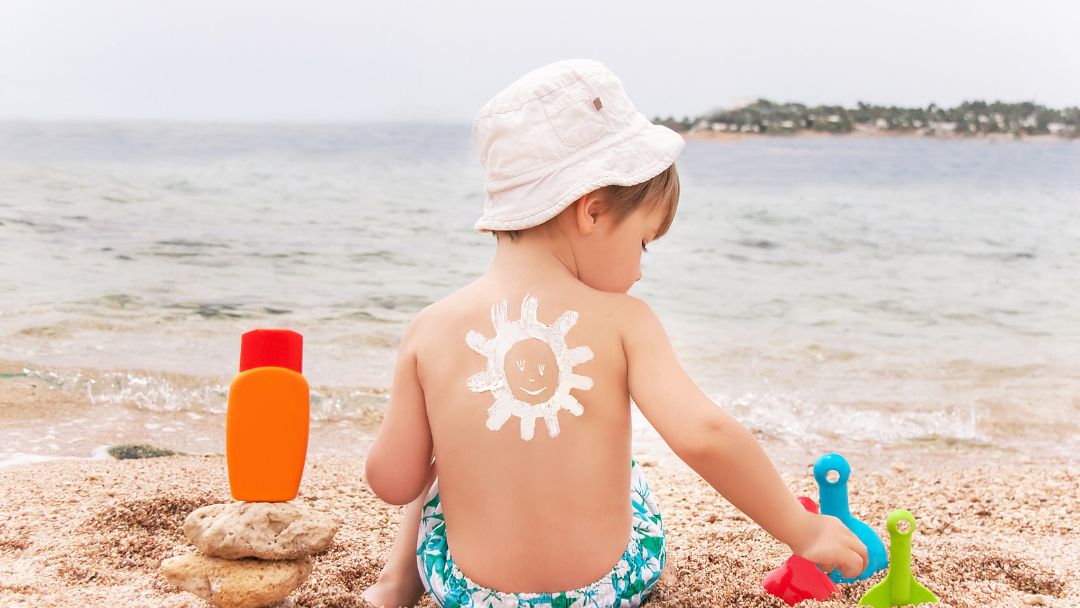 Baby wearing a sun hat outdoors for summer sun protection