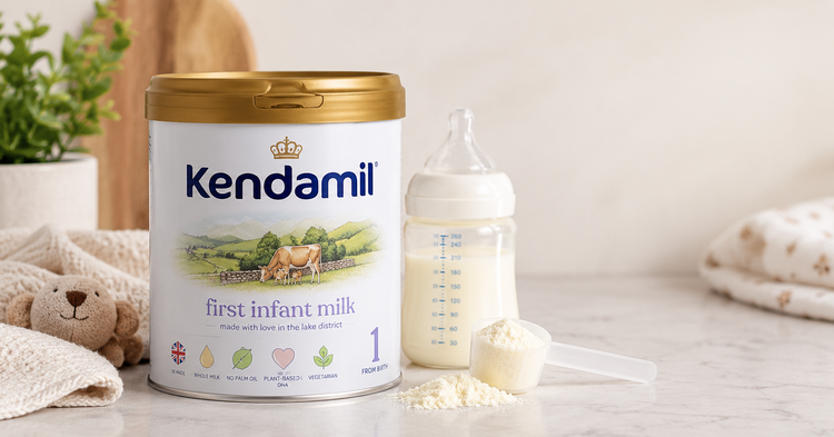 Kendamil First Infant Milk tin with baby feeding bottle and formula scoop