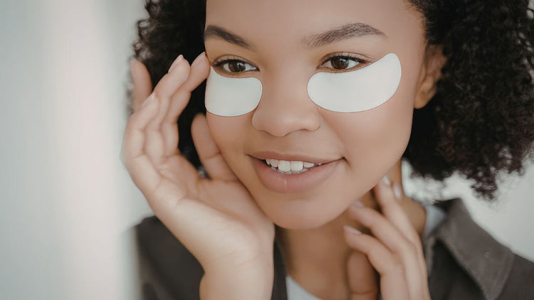 Woman applying eye cream for puffy eyes and dark circles