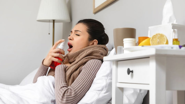 Person using a throat spray with sore throat lozenges for fast sore throat relief.