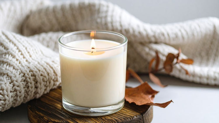 Autumn home fragrance with a scented candle and cosy seasonal décor