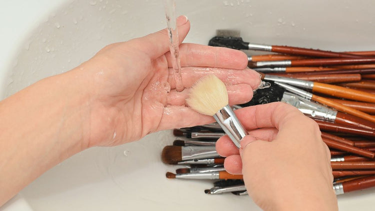 Makeup brushes and sponge being cleaned for better beauty tool hygiene