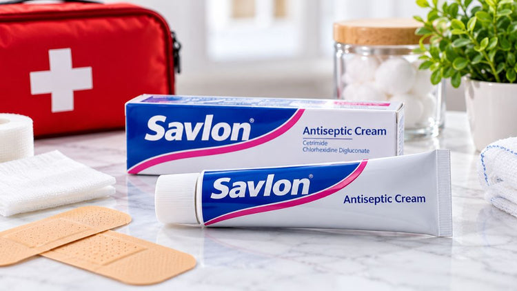 Savlon antiseptic cream tube and packaging with first aid supplies for minor cuts, grazes and skin care.
