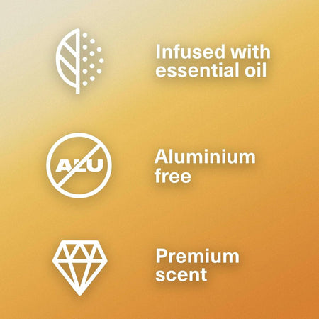 Three white feature icons on a warm yellow-to-orange gradient background: a leaf with droplets next to 'Infused with essential oil,' a crossed-out 'ALU' symbol next to 'Aluminium free,' and a diamond icon next to 'Premium scent.'.
