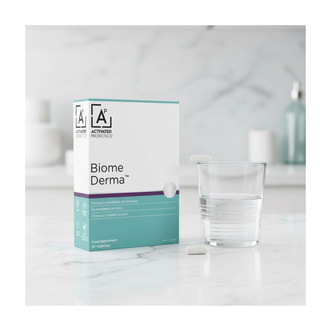 Activated Probiotics Biome Derma 30 Capsules packaging on a marble counter with a glass of water