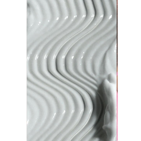 A close-up of a glossy white textured surface with repeating curved ridges and a soft shadow on the right side.
