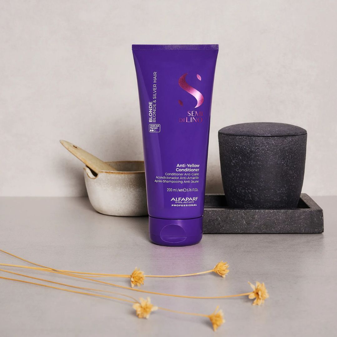 Purple conditioner bottle with decorative elements on a neutral background
