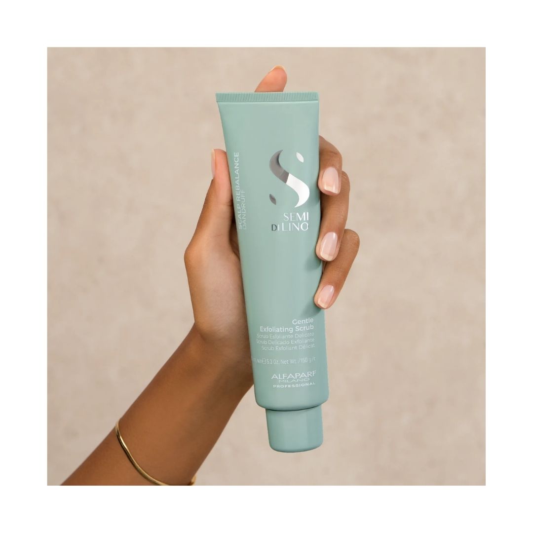 Alfaparf Semi di Lino Scalp Rebalance Gentle Exfoliating Scrub container in a womans hand