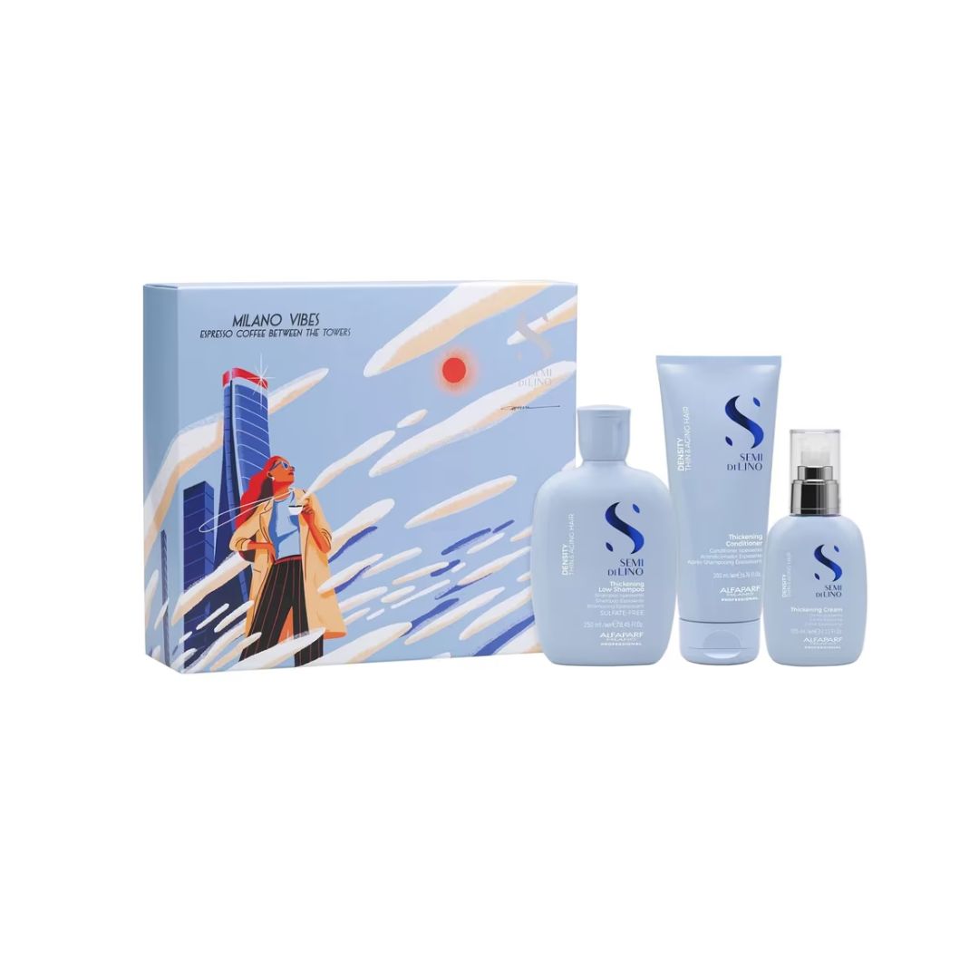 A haircare set by Alfaparf Milano Semi Di Lino Density Gift Set and contents featuring a light blue illustrated box and three matching bottles and tubes with blue and white labeling, set against a plain white background.