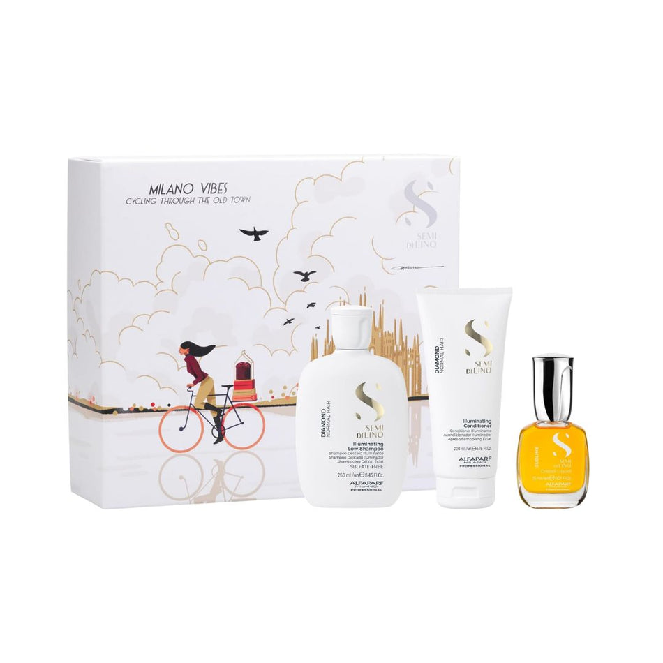  Alfaparf Milano Semi Di Lino Diamond Gift Set and contents on a white background grooming set featuring a white illustrated box, a white shampoo bottle, a white body wash tube, and a small yellow fragrance bottle on a white background.