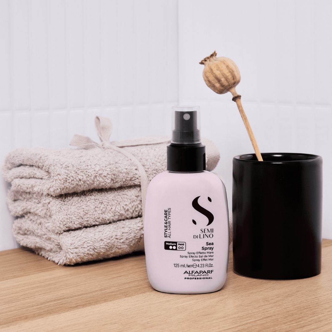 Alfaparf Milano Semi Di Lino Sea Spray 125ml on a bathroom dresser with towels