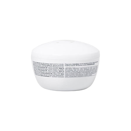 A white cosmetic jar with a matching lid, shown from the back to display the fine print text on the label, set against a plain white background.