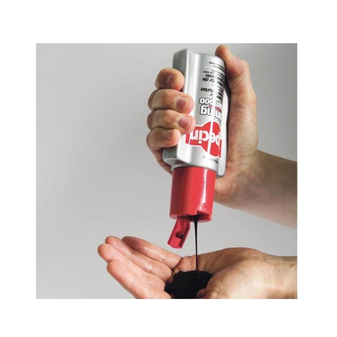 Alpecin Tuning Caffeine Shampoo being poured from the bottle into a man's hand