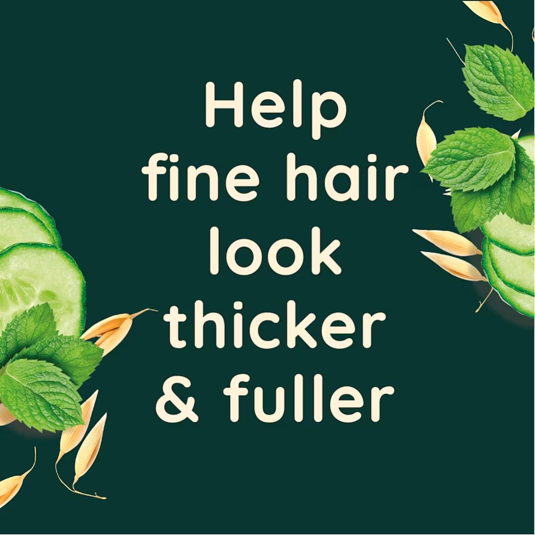 A dark green square graphic with cream text reading 'Help fine hair look thicker & fuller' and decorative green leaves, cucumber slices, and oat-like grains around the edges.