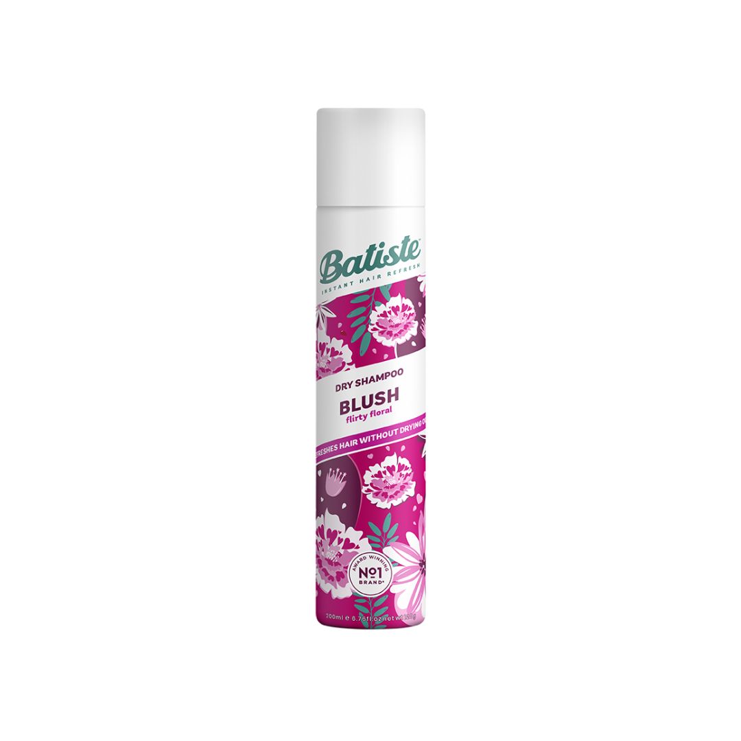 A can of Batiste Dry Shampoo in the Blush body spray scent, featuring a white cap and a label with pink and purple floral illustrations on a white background.