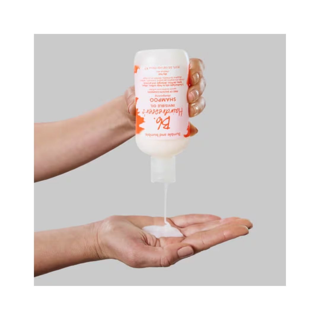 Bumble and bumble Hairdresser's Invisible Oil Shampoo 250ml being pured into a persons hand 