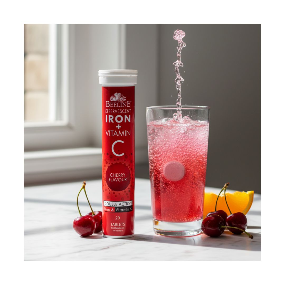 Beeline Iron + Vitamin C Cherry Effervescent Tablets container beside a glass of water with a tablet in