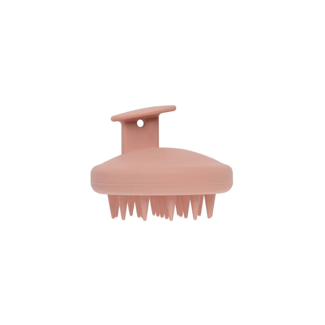 A dusty pink silicone scalp massage brush with a curved handle and soft bristles, shown against a plain white background.