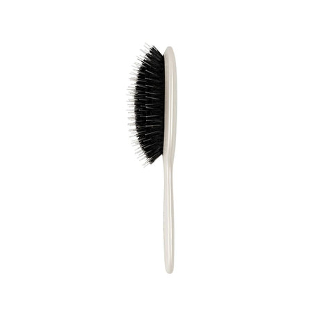 A classic hairbrush with black bristles and a cream-colored plastic handle, shown vertically against a plain white background.