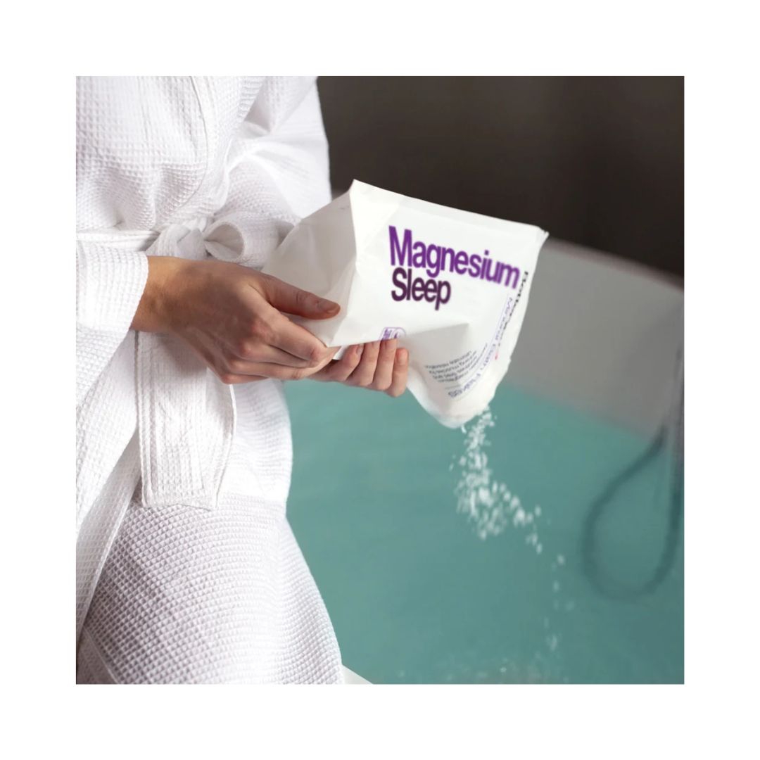 Better You Magnesium Sleep Bath Flakes being added to a bath