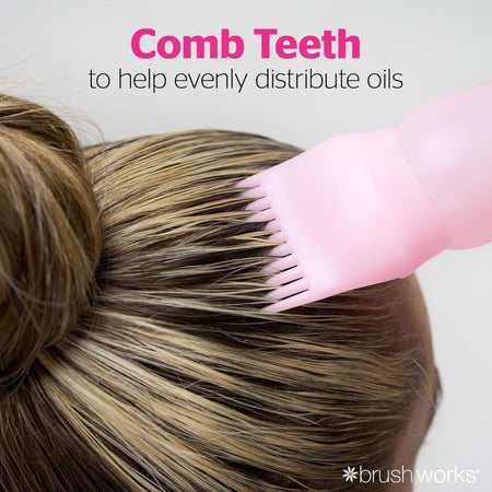 A pink silicone teeth comb tool applied to a person's hair bun, with text reading 'Comb Teeth to help evenly distribute oils' and a brushworks logo.