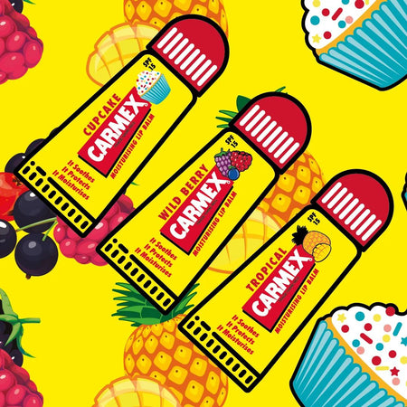 Carmex Minis SPF15 Lip Balm 3 Pack contents on a yellow fruity background