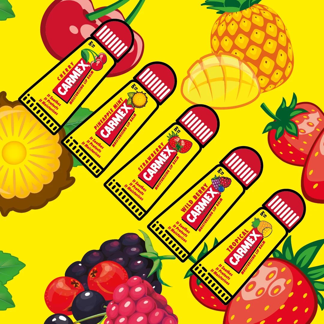 Carmex Minis Lip Balm 5 Pack contents on a yellow fruity background