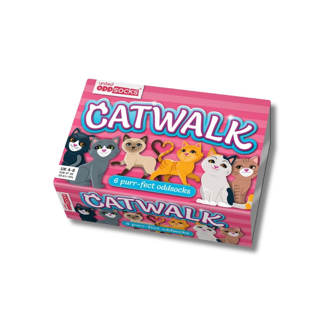 A boxed product labeled 'CATWALK' by Oddsocks, shown at an angle on a plain white background. The box is pink with cartoon cat illustrations and text indicating '6 purr-fect oddsocks'.