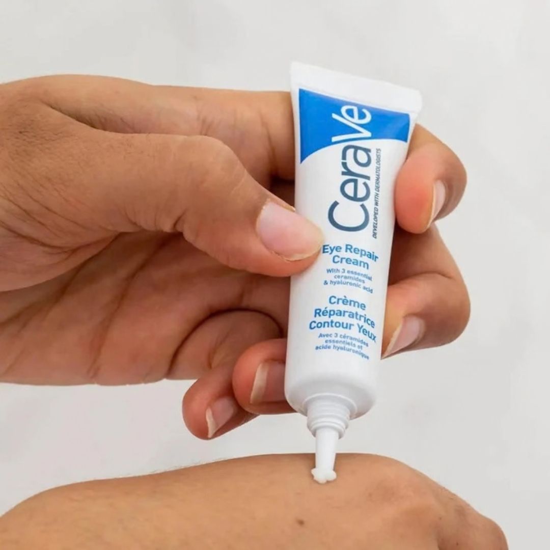 Hand applying CeraVe eye repair cream to skin