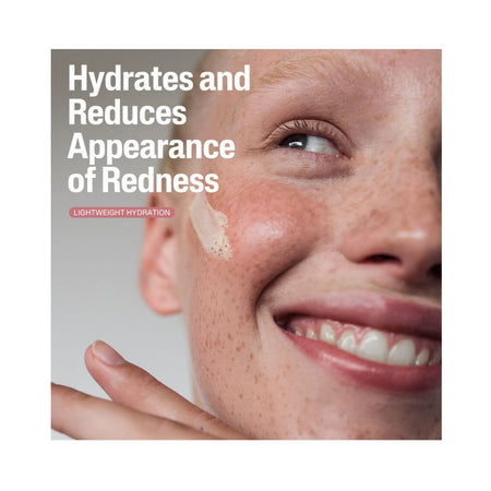 Close-up of a smiling person with freckles and a smear of cream on the cheek, with text reading 'Hydrates and Reduces Appearance of Redness' and a small label 'Lightweight Hydration'.