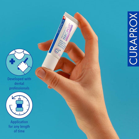 Hand holding a Curaprox Perio Plus tube against a blue background with brand logo.