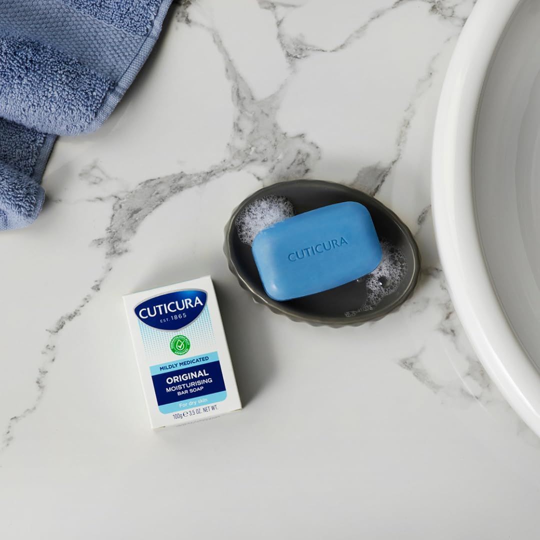 Cuticura Mildly Medicated Bar Soap 100g on a marble bathroom counter