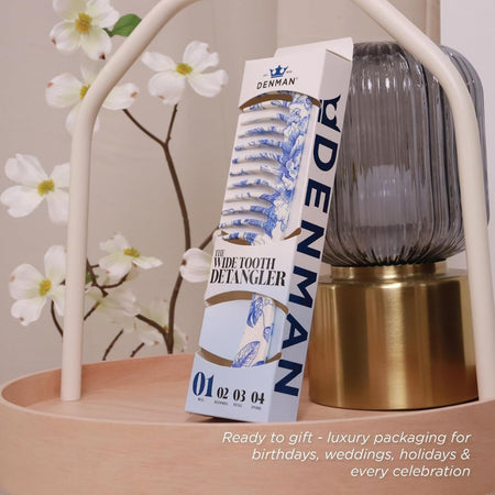 Denman D28 Deluxe Wide Tooth Detangler Comb Blue Belle on a cabinet with floral background