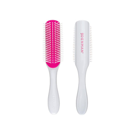 Two Denman hairbrushes shown side by side on a plain white background, one displaying the bright pink bristles and white handle, and the other showing the white handle with pink bristles.
