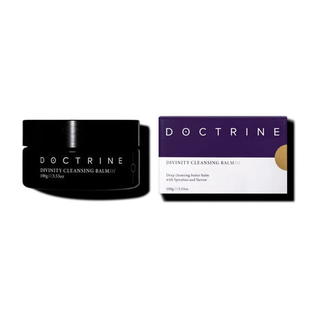 Black jar and purple box of Doctrine Divinity Cleansing Balm on a white background