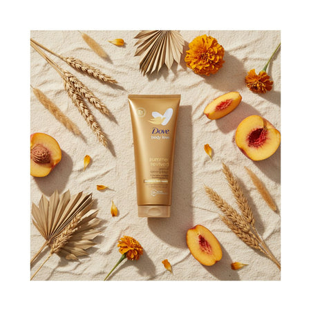 A tube of Dove Soft Touch body wash is centered in a styled flat-lay arrangement on a textured beige surface, surrounded by dried palm leaves, wheat stalks, orange marigold flowers, peach slices, and scattered petals.
