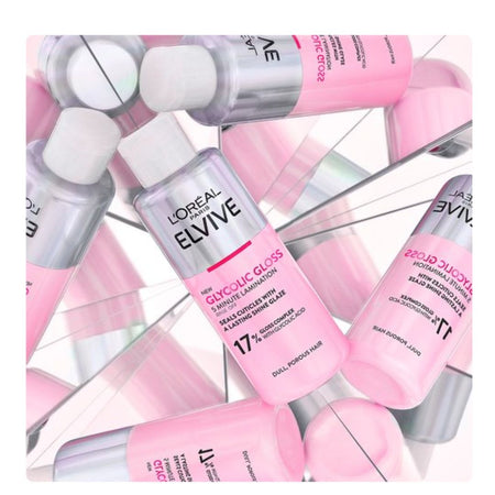L'Orétal Paris Lévive Glycine Gloss hair serum bottles arranged in a mirrored, overlapping pattern. The bottles are pink and silver with white caps, showcasing the product packaging on a reflective surface.