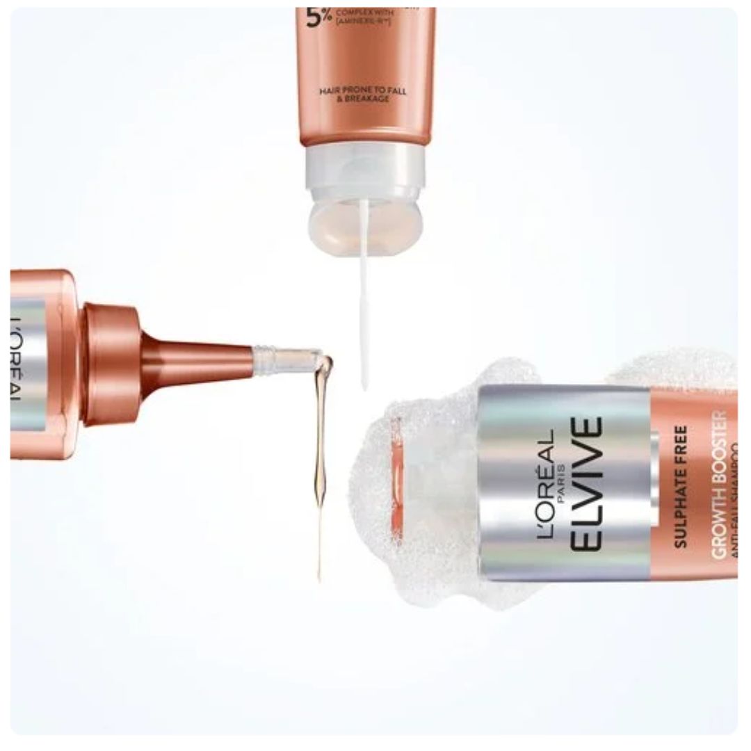 Three L'Oréal Paris L'Elvive Sulphate Free Hair Growth Booster bottles and applicators arranged on a clean white background, showing the product packaging and a drop of the clear liquid formula.