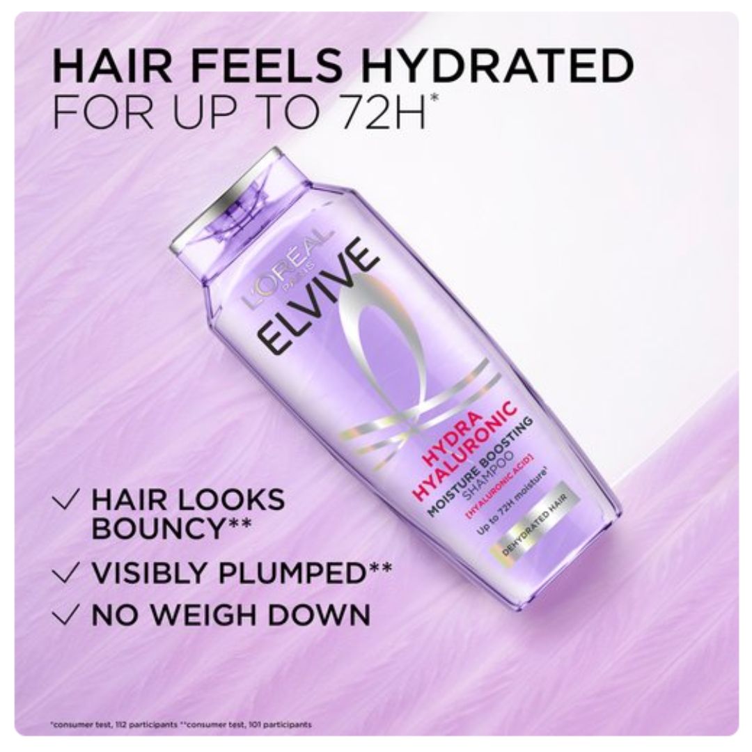 L'Oréal Elvive Hydra Hyaluronic Moisture Boosting Hair Conditioner bottle shown on a light purple textured background with promotional text.