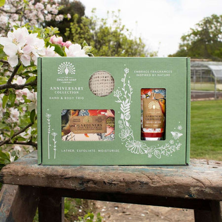 The English Soap Company Pink Grapefruit Hand & Body Trio on a floral garden background