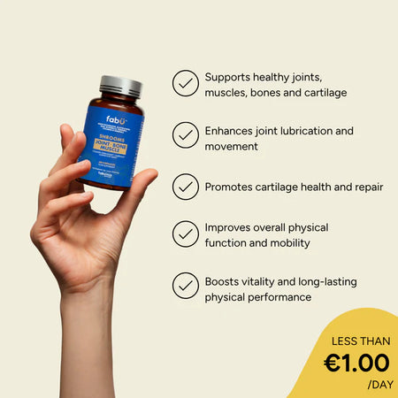 Hand holding a supplement bottle with health benefits listed on a beige background
