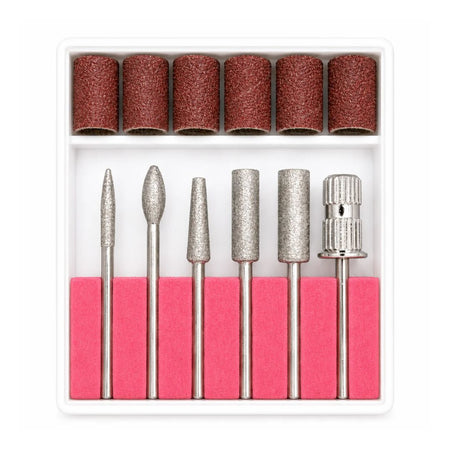 A 7-piece nail drill bit set with various metal diamond and abrasive bits, shown in a white plastic organizer tray with six brown sanding rolls on top and pink foam grips underneath.