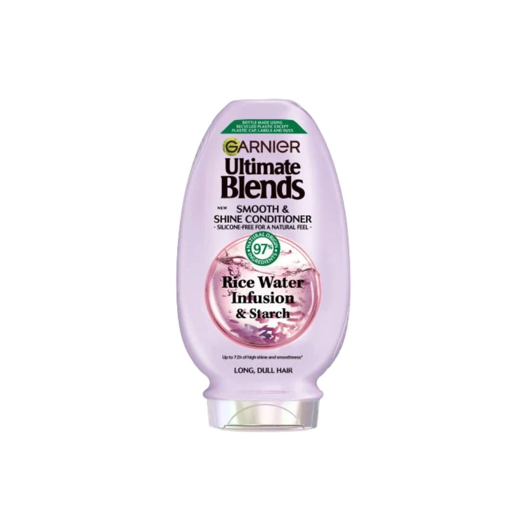 A bottle of Garnier Ultimate Blends Smooth & Shine Conditioner in Rice Water Infusion & Starch, featuring a light purple bottle with a clear cap on a white background.