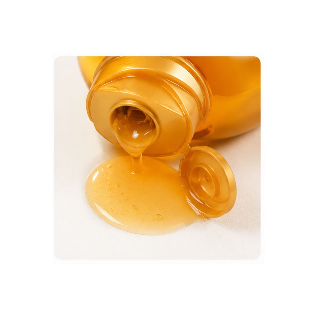 Garnier Ultimate Blends Argan Oil & Camellia Oil Shampoo bottle pouring onto counter top