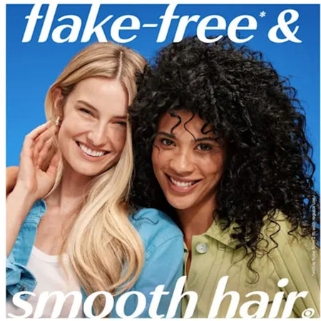 A promotional beauty ad showing two smiling women against a bright blue background, with large text reading 'flake-free & smooth hair.'