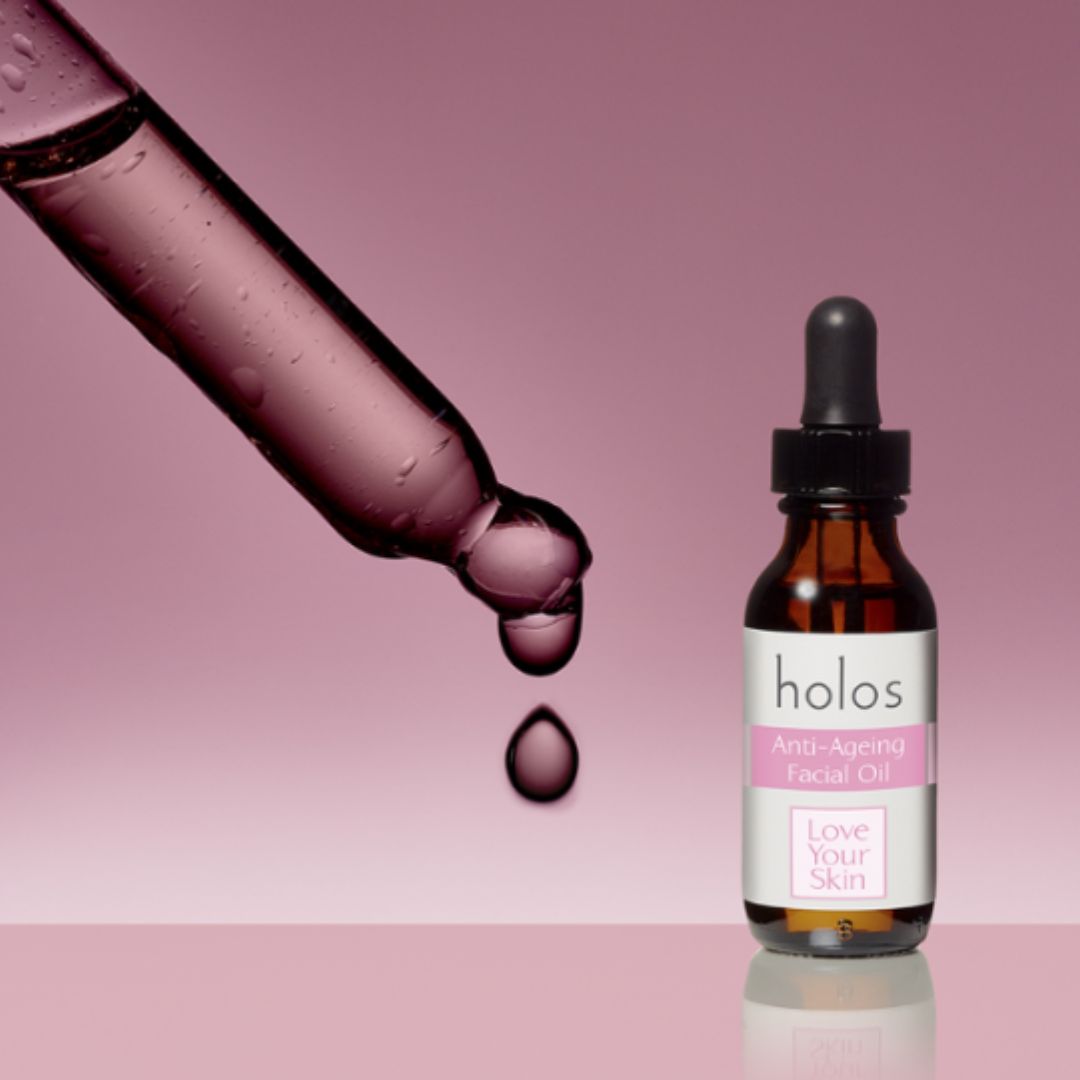 Holos Anti-Ageing Facial Oil on a pink background