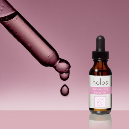 Holos Anti-Ageing Facial Oil on a pink background
