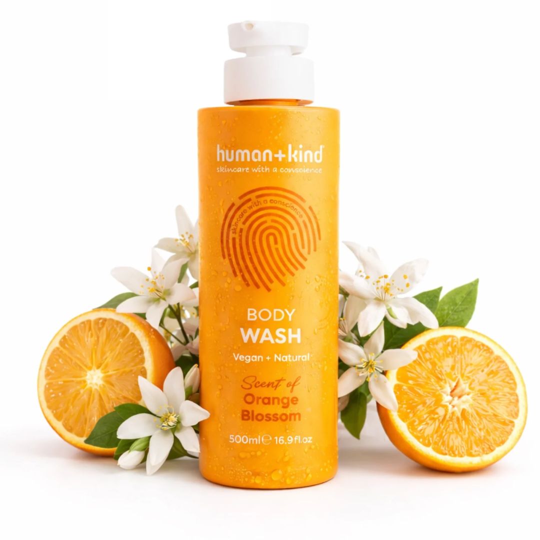 Human+Kind Orange Blossom Body Wash  on a white background with orange slices and flowers
