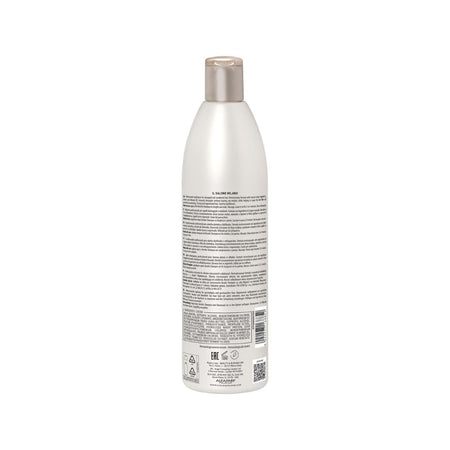 The back view of a tall, white plastic bottle with a metallic silver cap, featuring dense black text and regulatory labels on its side, set against a plain white background.