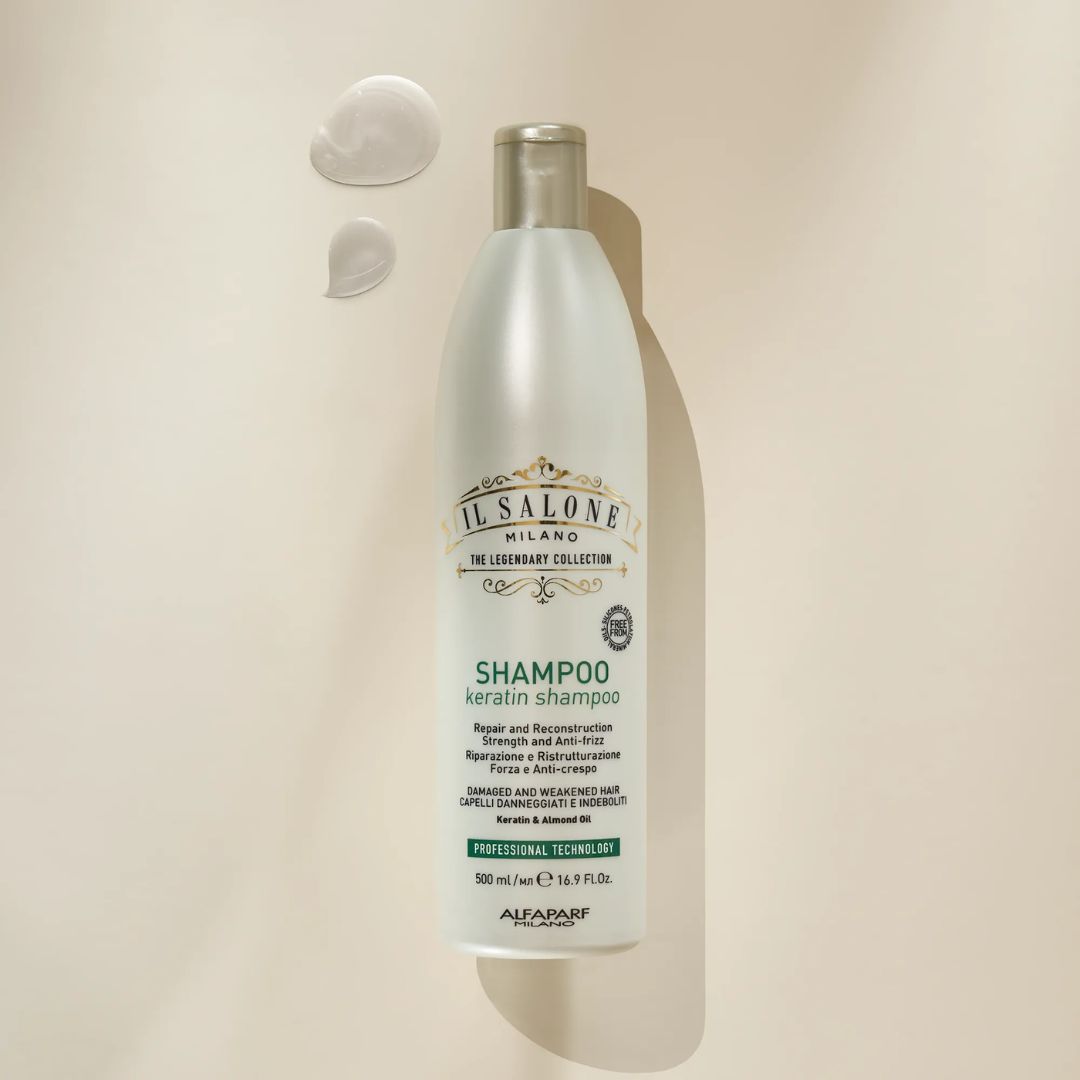 A 500ml bottle of IL SALONE Milano The Legendary Collection Shampoo Keratin Shampoo, displayed on a warm beige background with two dollops of white cream above it.